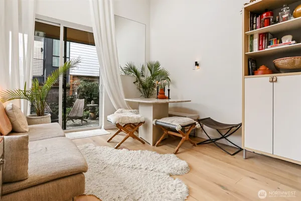 a living room with furniture a rug and a potted plant