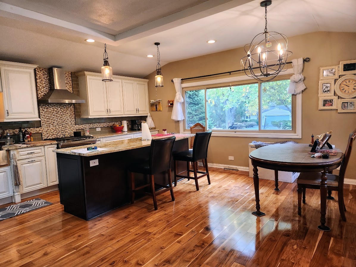 2246 Alta Vista Drive Waukegan, IL 60087 - Photo 9 of 46 a kitchen with stainless steel appliances granite countertop a stove a refrigerator a sink dishwasher a dining table and chairs with wooden floor