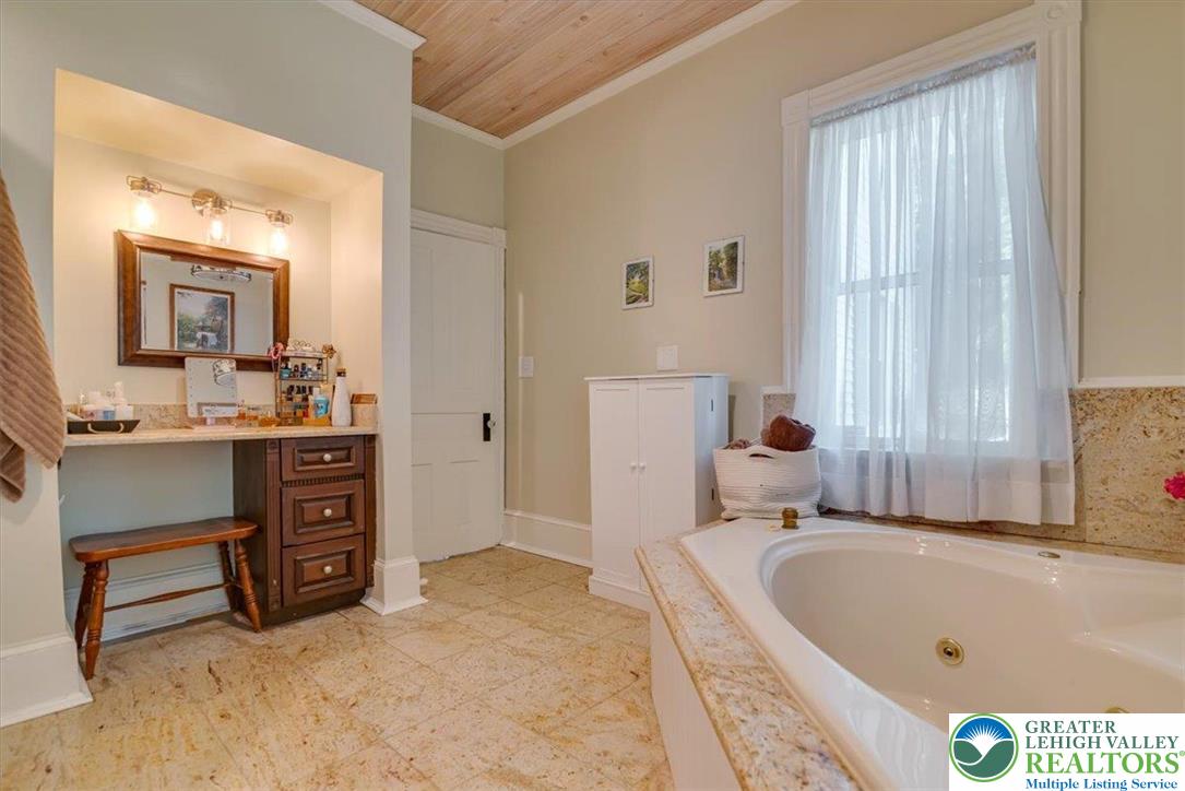 3585 Fairyland Road Lehighton, PA 18235 - Photo 37 of 67 a bathroom with a tub a sink and a large mirror