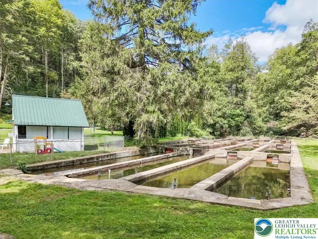 a view of a backyard with wooden fence