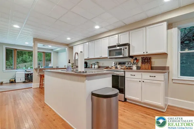 a spacious bedroom with a bed and a book shelf