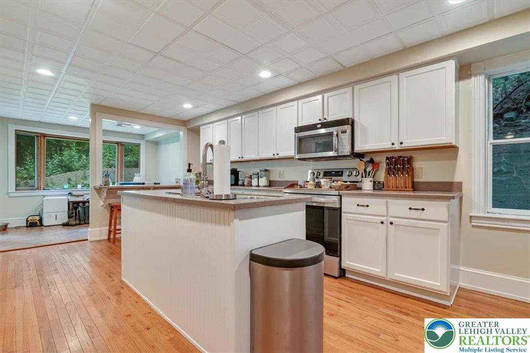 3585 Fairyland Road Lehighton, PA 18235 - Photo 10 of 67 a kitchen with stainless steel appliances granite countertop a refrigerator a sink dishwasher a stove and white countertops with wooden floor