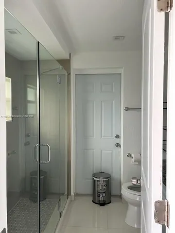 a bathroom with a shower and a toilet
