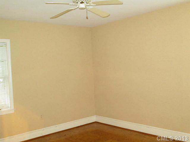 500 Ashworth Road Charlotte, NC 28211 - Photo 7 of 12 an empty room with a window and a fan