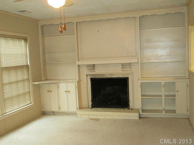 500 Ashworth Road Charlotte, NC 28211 - Photo 8 of 12 a view of an empty room with a fireplace and a window