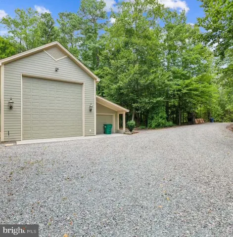 a spacious bedroom with a bed and a large window