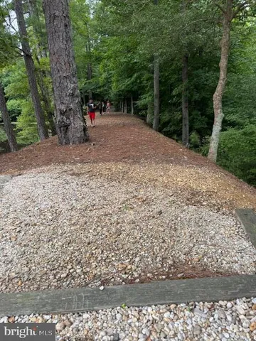 an aerial view of a house with garden space and lake view