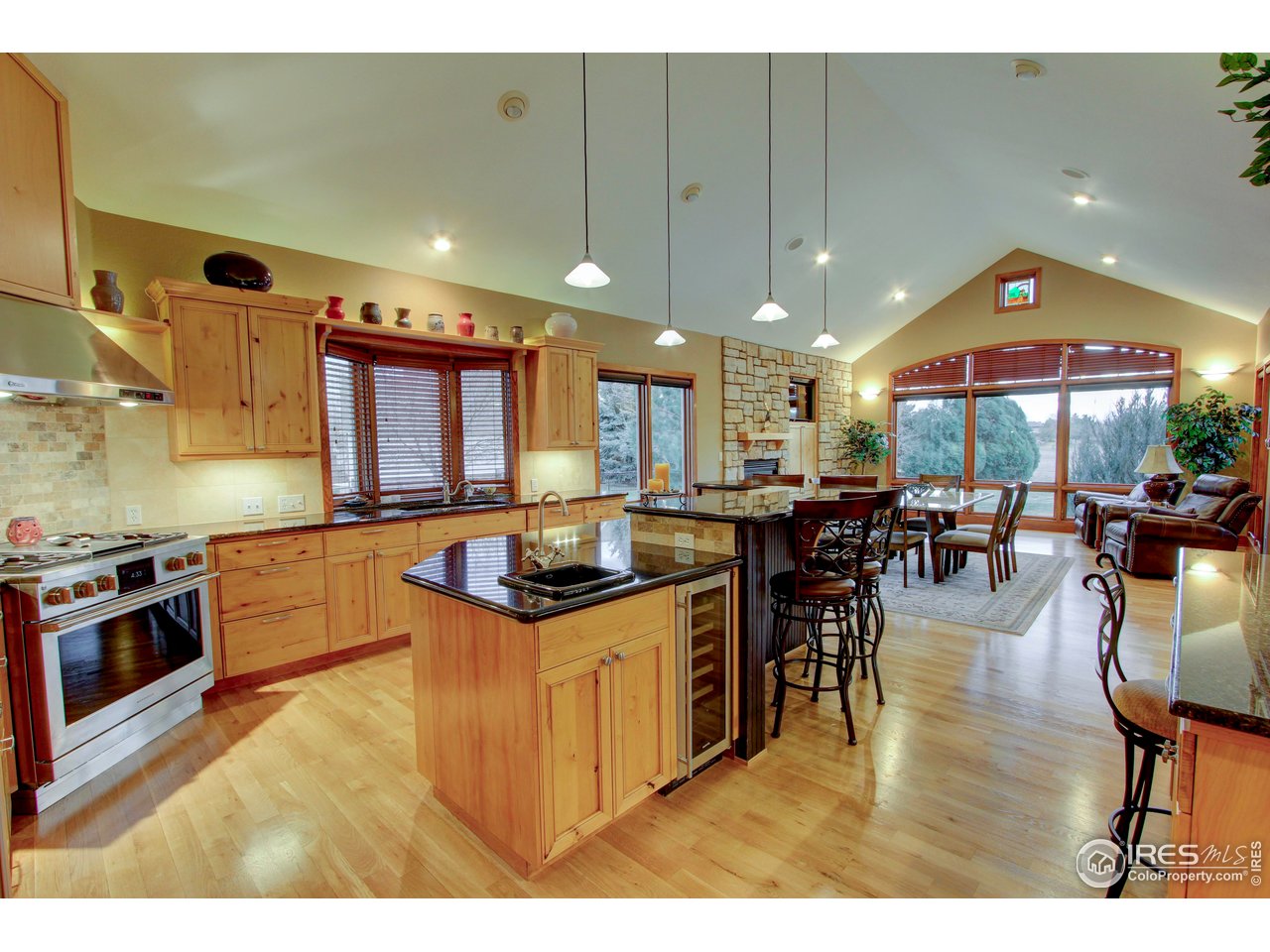 7848 Eagle Ranch Road Fort Collins, CO 80528 - Photo 13 of 46 a kitchen with stainless steel appliances granite countertop a stove top oven a dining table and chairs