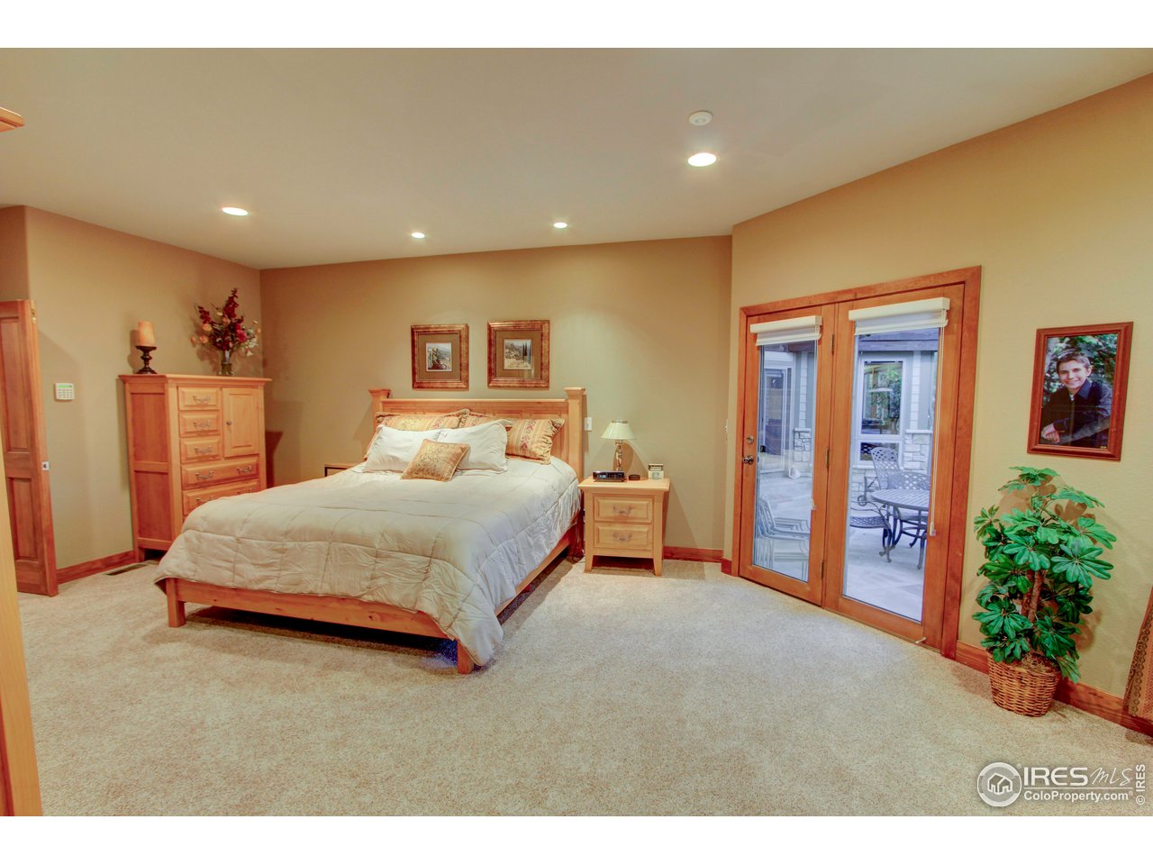 7848 Eagle Ranch Road Fort Collins, CO 80528 - Photo 16 of 46 a bedroom with a large bed and a chandelier