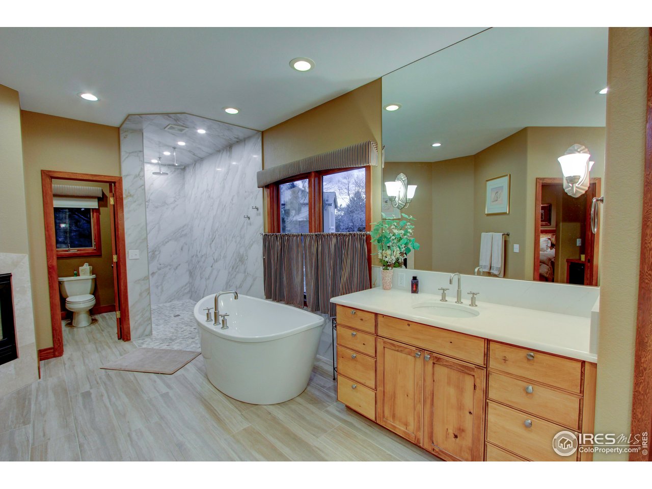 7848 Eagle Ranch Road Fort Collins, CO 80528 - Photo 20 of 46 a bathroom with a toilet sink and mirror