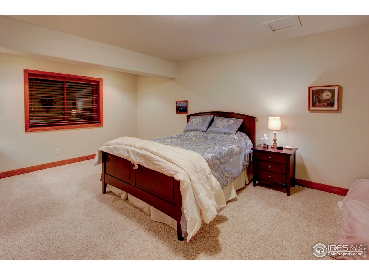 7848 Eagle Ranch Road Fort Collins, CO 80528 - Photo 33 of 46 a spacious bedroom with a bed and a lamp