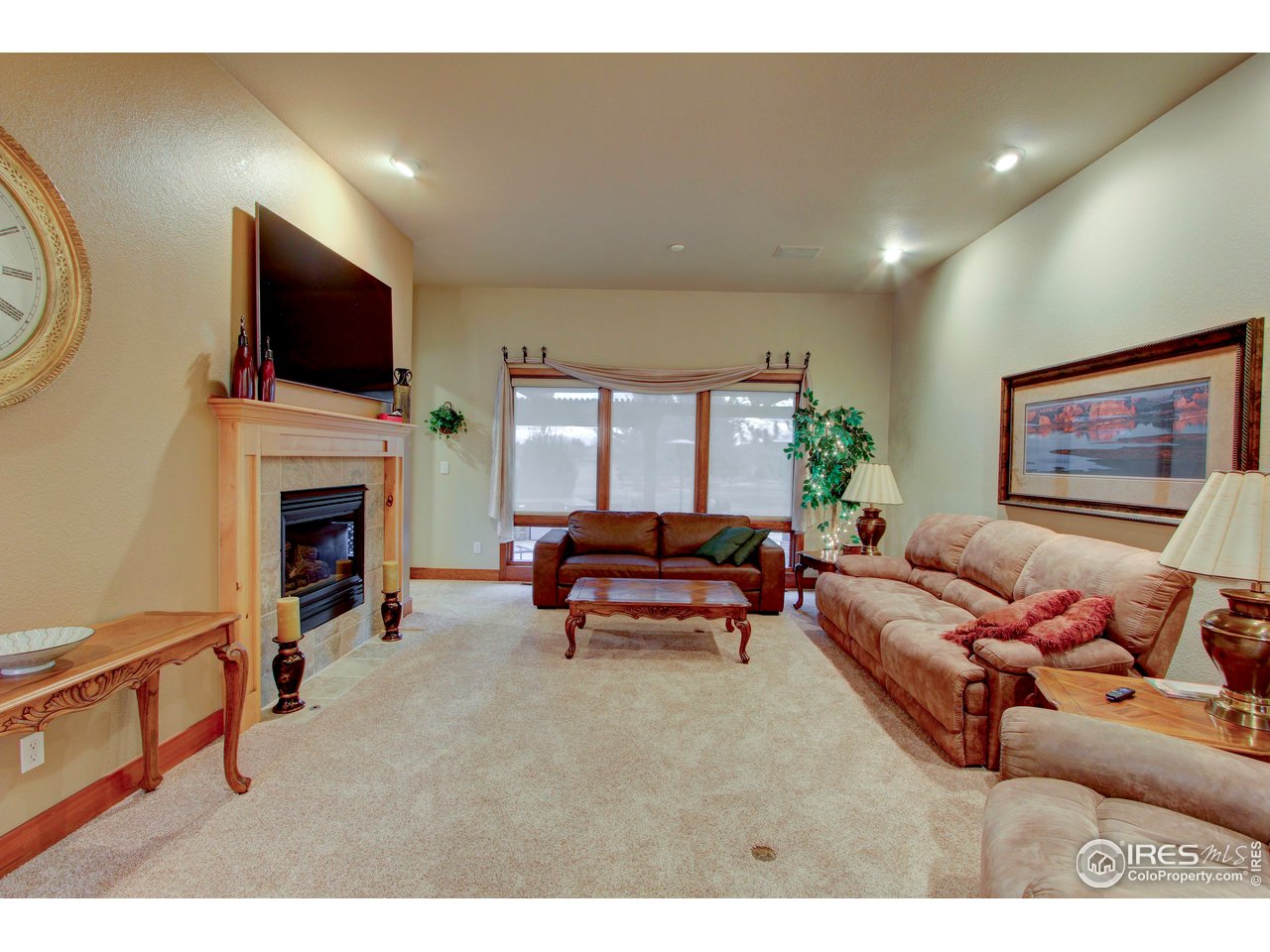 7848 Eagle Ranch Road Fort Collins, CO 80528 - Photo 8 of 46 a living room with furniture a flat screen tv and a fireplace