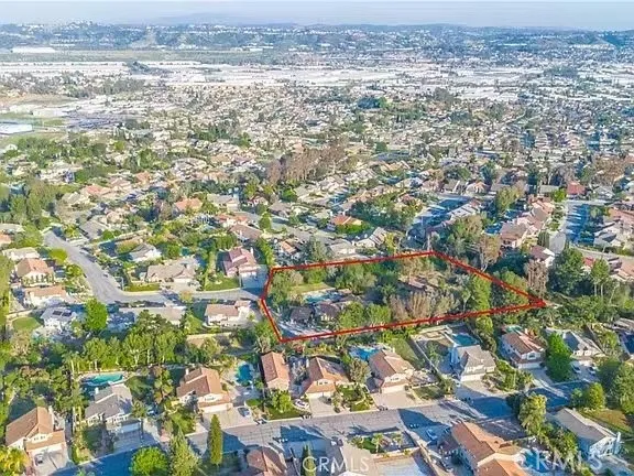 an aerial view of a house with swimming pool and outdoor space