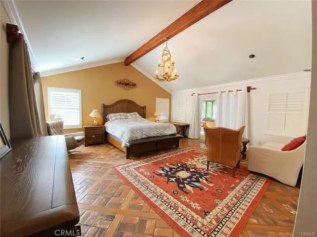 a bedroom with furniture and wooden floor