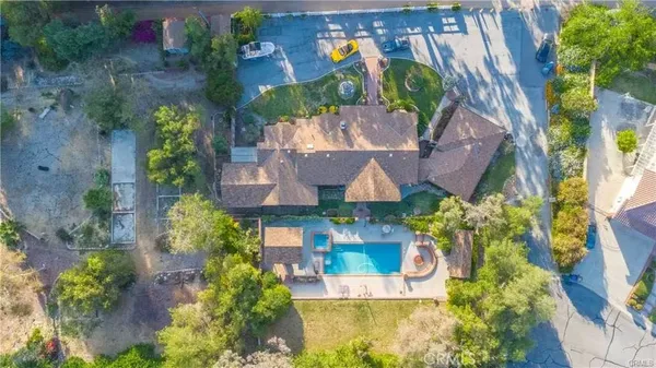 an aerial view of a house with a yard