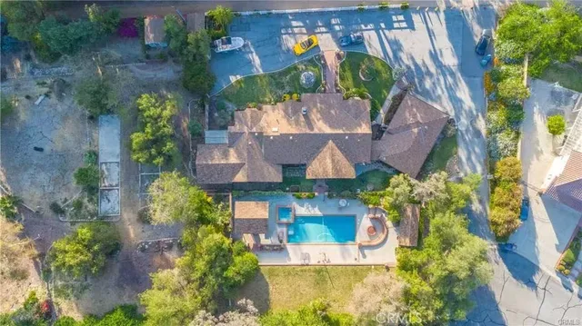 an aerial view of a house with a yard