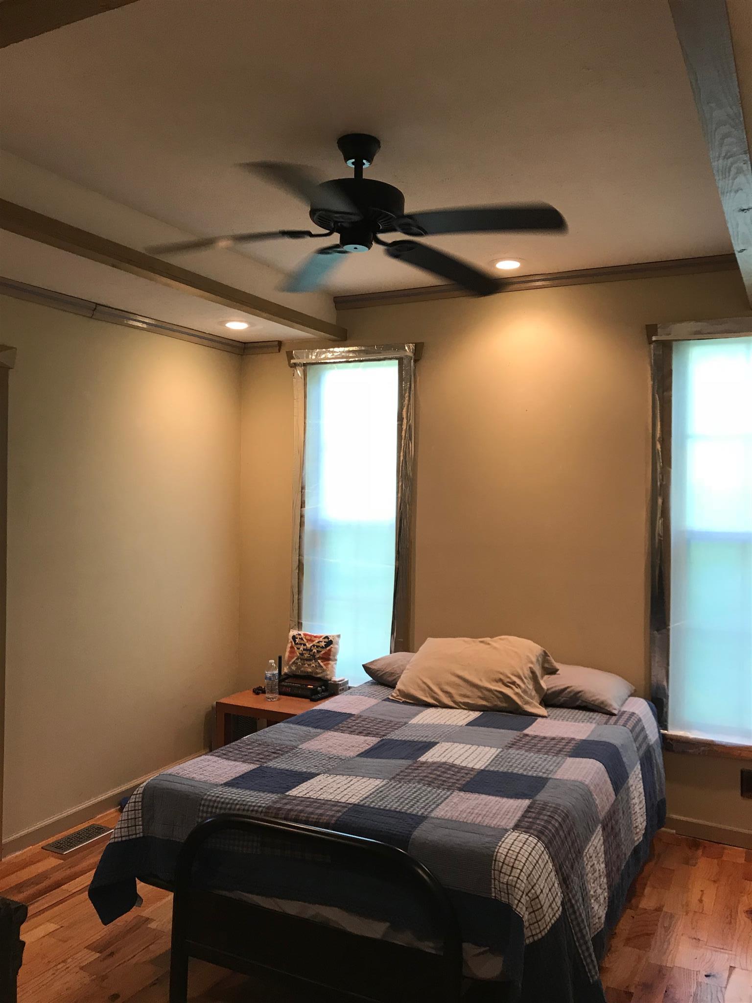524 Sam Hollow Road Dickson, TN 37055 - Photo 12 of 13 a bedroom with a bed and a chandelier