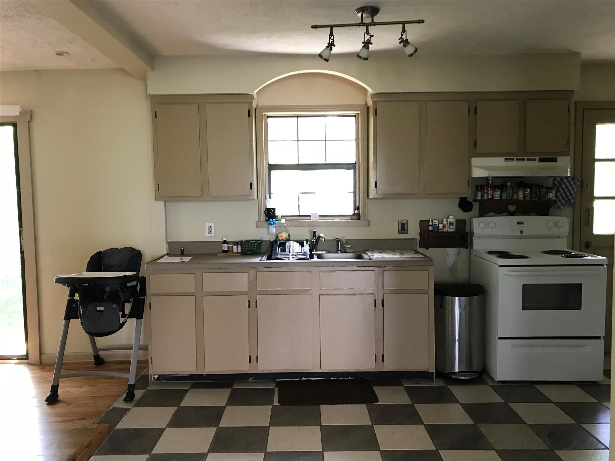 524 Sam Hollow Road Dickson, TN 37055 - Photo 8 of 13 a kitchen with a stove a sink and a window
