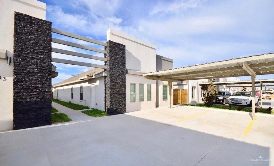 View of front of house with a pergola and stucco siding