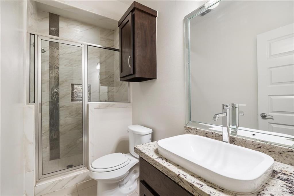 1716 West Garrison Drive, Unit 2 Pharr, TX 78577 - Photo 12 of 17 Bathroom featuring vanity and a stall shower