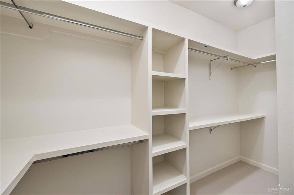 1716 West Garrison Drive, Unit 2 Pharr, TX 78577 - Photo 9 of 17 Walk in closet with light tile patterned flooring
