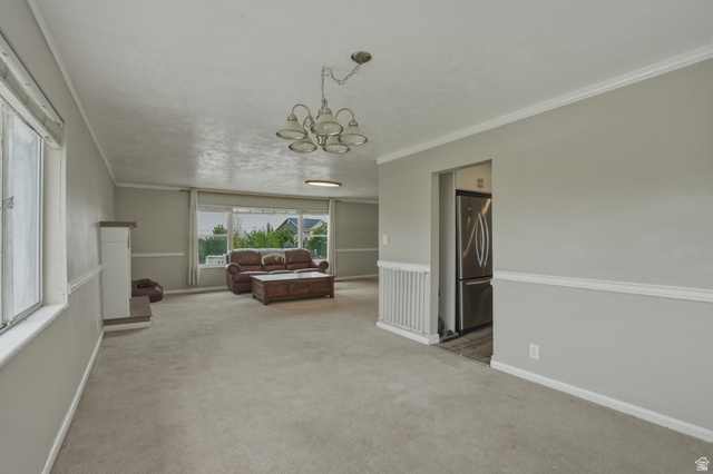 500 North 800 East Springville, UT 84663 - Photo 10 of 51 Interior space with ornamental molding, a chandelier, and light carpet