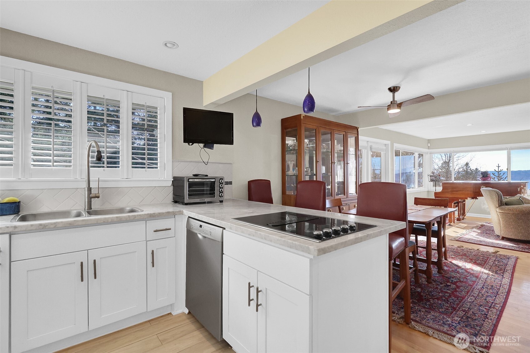 2424 Southwest 152nd Street Burien, WA 98166 - Photo 15 of 39 a kitchen with a stove a sink a dining table and chairs