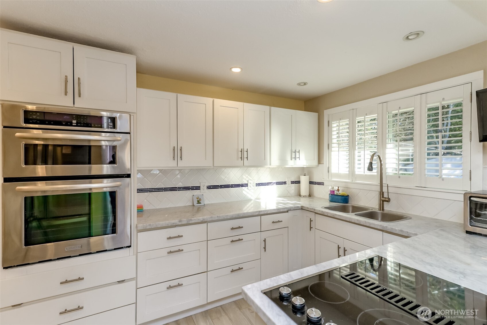 2424 Southwest 152nd Street Burien, WA 98166 - Photo 16 of 39 a kitchen with granite countertop white cabinets and stainless steel appliances