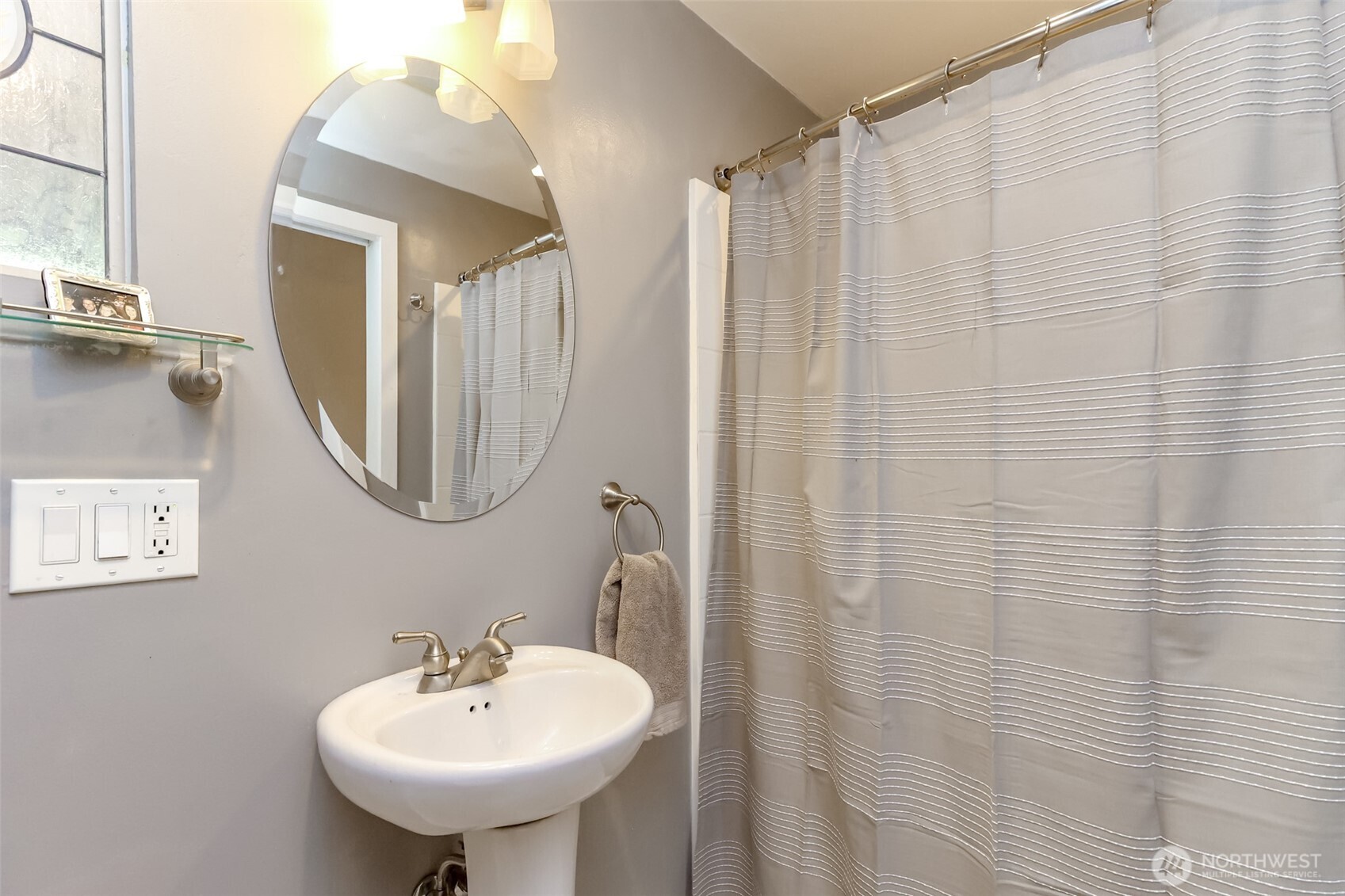 2424 Southwest 152nd Street Burien, WA 98166 - Photo 20 of 39 a bathroom with a sink a mirror and a shower curtain