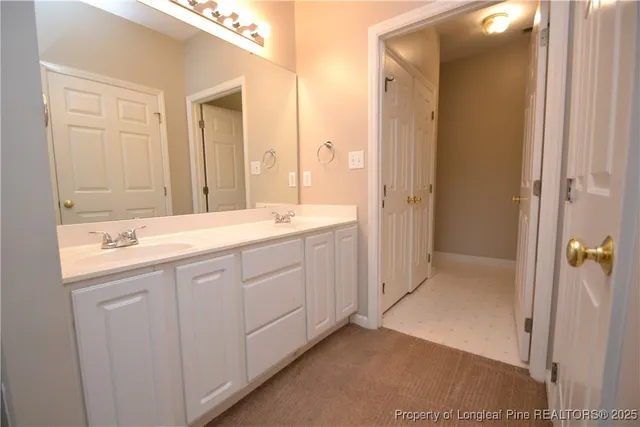 a white bath tub sitting next to a white sink