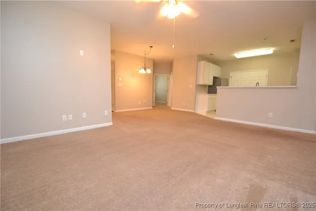a view of a kitchen with a sink and a refrigerator