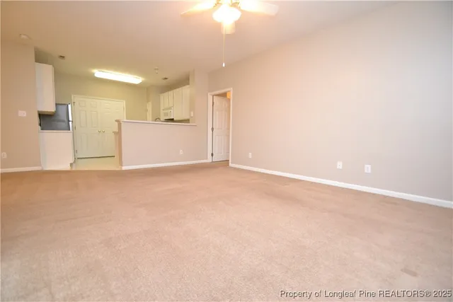 a kitchen with a refrigerator a stove a microwave and cabinets