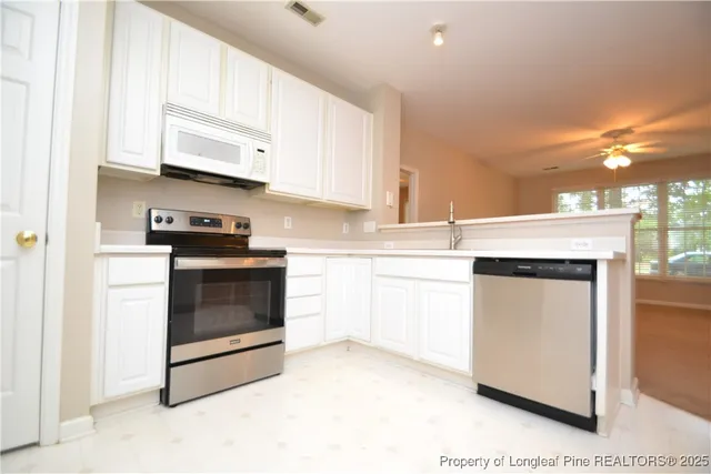 a kitchen with a refrigerator and a sink