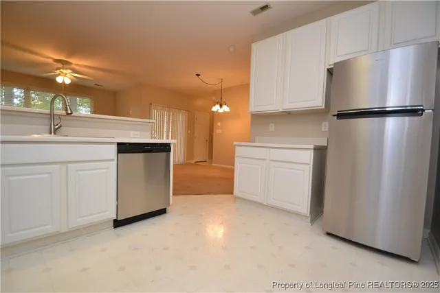 a view of a kitchen with a refrigerator and a microwave