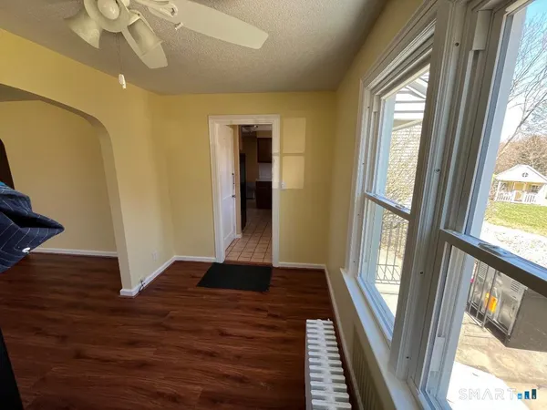 a view of an entryway door with wooden floor