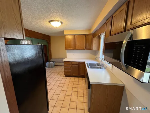 a kitchen with a sink and a refrigerator