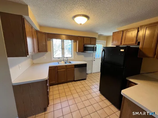 a kitchen with a sink a refrigerator and a stove
