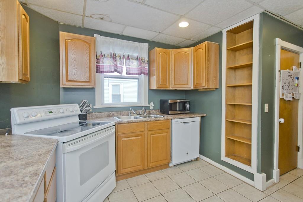 107 Ardmore Street Springfield, MA 01104 - Photo 5 of 30 a kitchen with a stove sink and cabinets