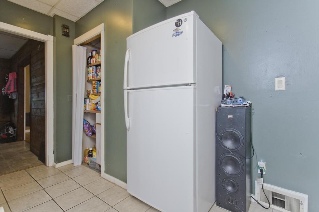 107 Ardmore Street Springfield, MA 01104 - Photo 7 of 30 a white refrigerator freezer and a stove sitting inside of a kitchen