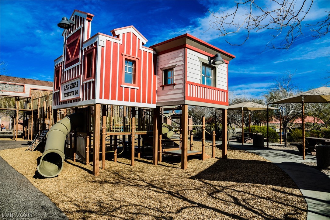 9916 Sable Point Street Las Vegas, NV 89178 - Photo 61 of 73 A vibrant play structure with a fun slide promises endless outdoor enjoyment under a bright sky.
