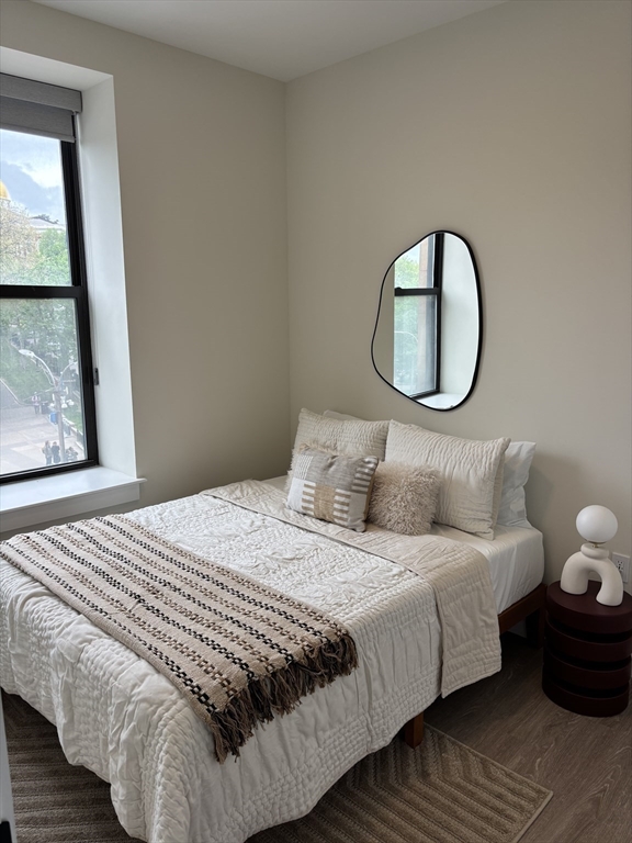 47 Winter Street, Unit 601 Boston, MA 02108 - Photo 6 of 12 a bedroom with a bed and window