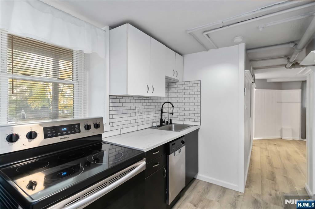 1283 Valley Road, Unit 7 Montclair, NJ 07043 - Photo 6 of 26 a kitchen with a stove and a white cabinet