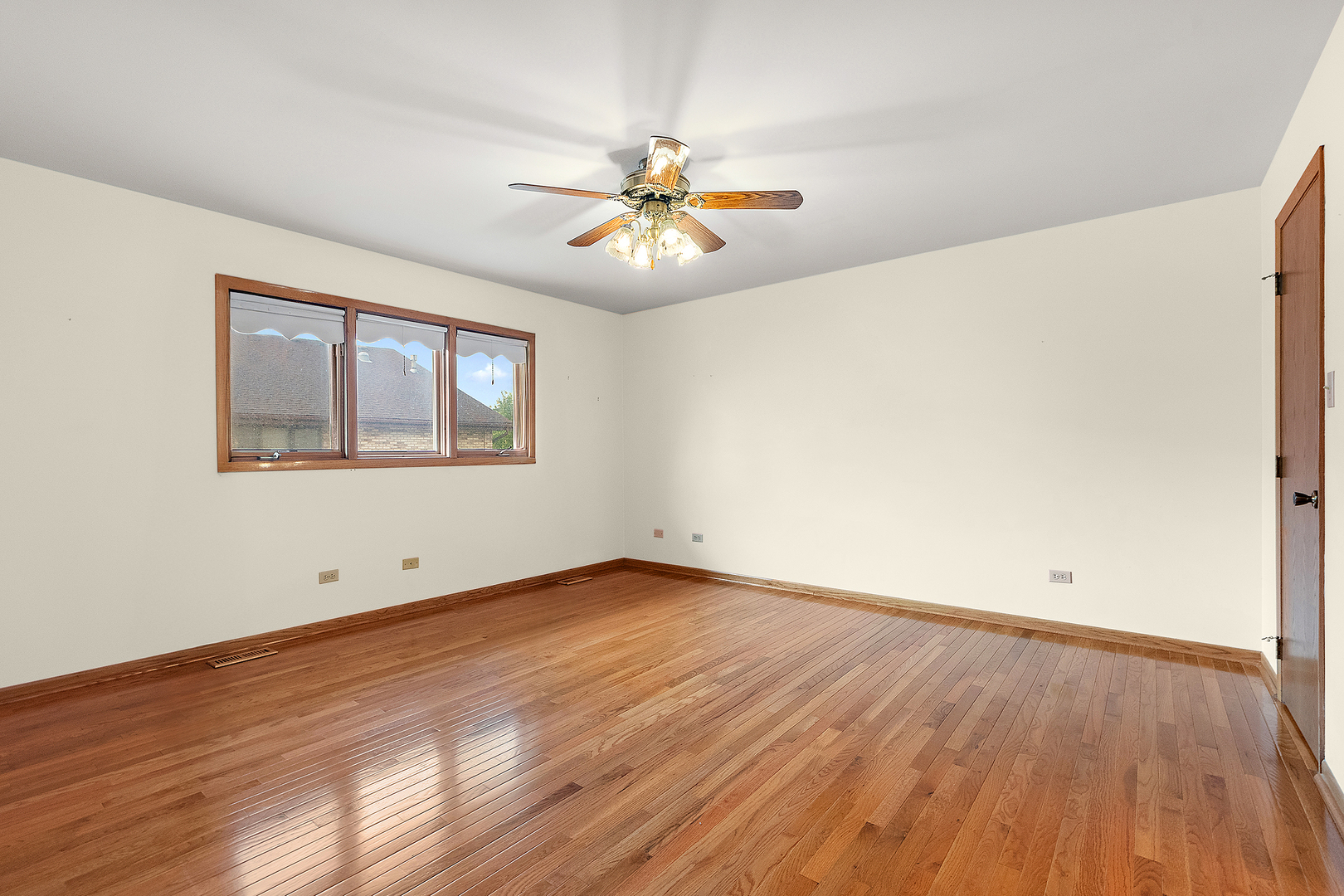 10459 Eagle Ridge Drive, Unit 139 Orland Park, IL 60467 - Photo 14 of 25 a view of an empty room with window and wooden floor