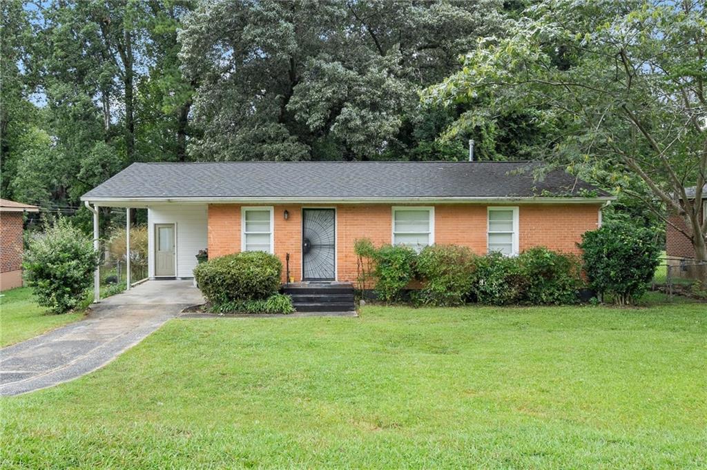 3793 Stone Road Southwest Atlanta, GA 30331 - Photo 1 of 1 a front view of a house with yard and green space