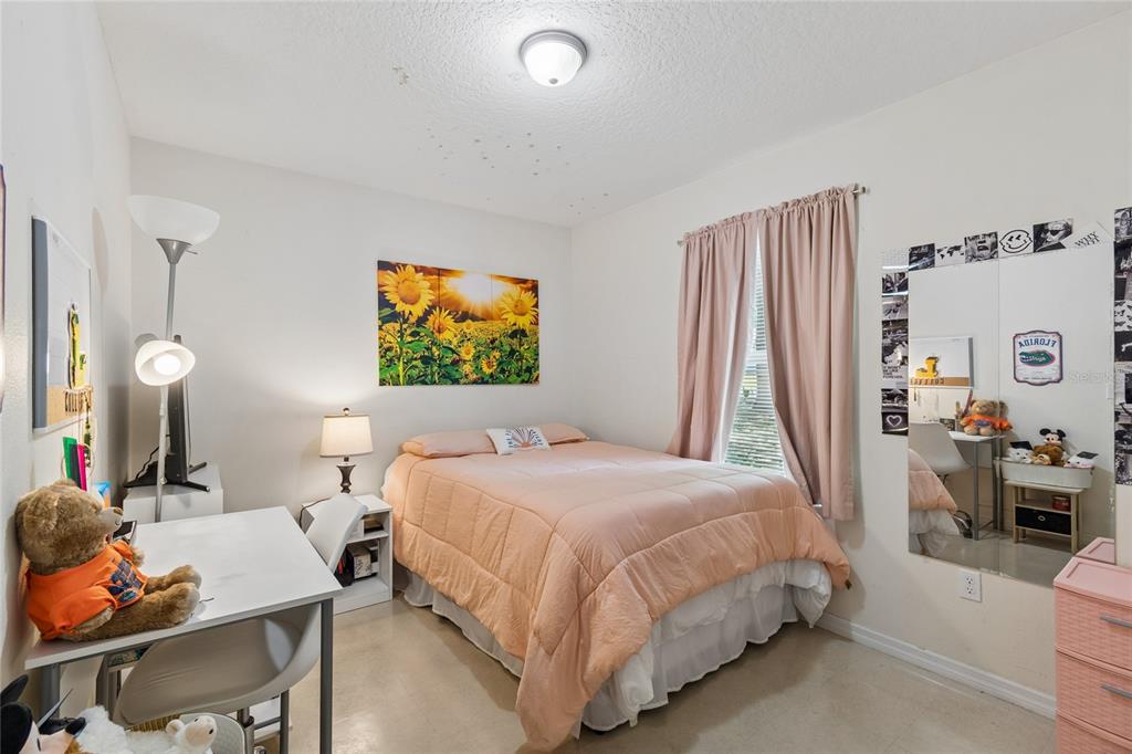 468 North Wheeler Avenue Inverness, FL 34453 - Photo 13 of 24 a bedroom with a bed and wooden floor
