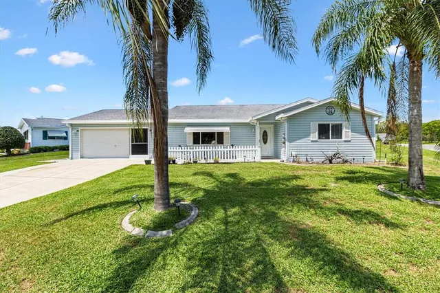 a front view of house with yard and green space