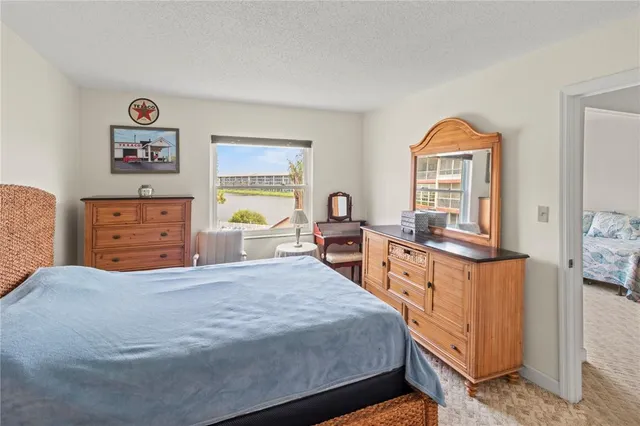 a large bedroom with a bed and a dresser