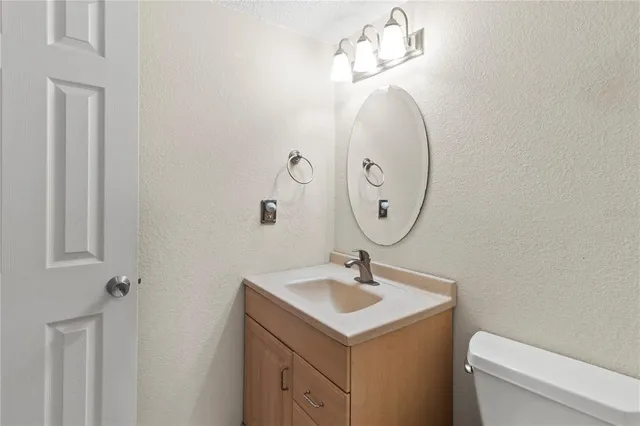 a bathroom with a sink a mirror and a toilet
