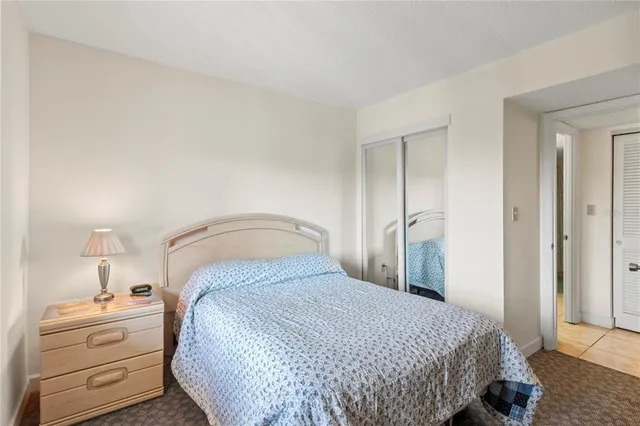 a bedroom with a bed and cabinet