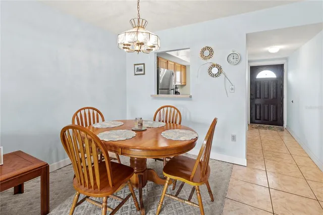 a view of a dining room with furniture and chandelier